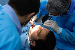 a woman is getting dental treatment.