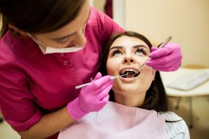 a woman is getting dental treatment.