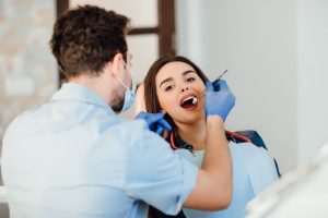 a woman is getting dental treatment.